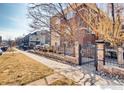 Brick apartment complex featuring gated entries and sidewalks, situated on a grassy plot on a sunny day at 2345 N Clay St # 6, Denver, CO 80211