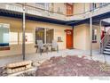 Outdoor patio featuring seating, a small garden, and access to upper-level apartments in a well-maintained complex at 2345 N Clay St # 6, Denver, CO 80211
