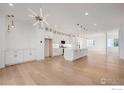 Bright, open-concept living room with modern finishes and hardwood floors throughout at 2361 Junegrass Ln, Superior, CO 80027