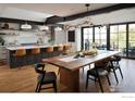 Open kitchen and dining area with island seating and access to outdoor balcony at 2828 4Th St, Boulder, CO 80304