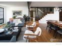 Sunlit living room with hardwood floors, modern decor, and staircase at 2828 4Th St, Boulder, CO 80304
