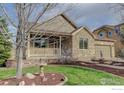 Beautiful exterior view of the home showcasing stone accents and a lovely landscaped front yard at 3008 Mountain Sky Dr, Castle Rock, CO 80104