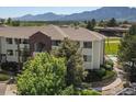 Beautiful condo exterior with manicured landscaping, mature trees and mountain views in the background at 33 S Boulder Cir # 316, Boulder, CO 80303