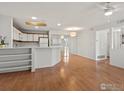 Bright living room with hardwood floors, white walls, modern lighting, and large mirrored closet doors at 33 S Boulder Cir # 316, Boulder, CO 80303