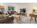 Cozy living room with comfortable seating, large window, and neutral color palette at 437 Fox St, Longmont, CO 80504