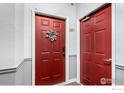 Apartment entrance showcasing a red door with unit number and decorative wreath at 4451 S Ammons St # 307, Littleton, CO 80123