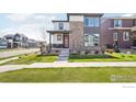 Modern two-story home with stone accents and well-manicured lawn at 6211 Stable View St, Castle Pines, CO 80108