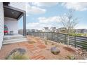 Landscaped front yard featuring modern walkway, rocks, and lush plantings at 6211 Stable View St, Castle Pines, CO 80108