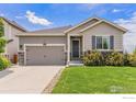 Inviting single-Gathering home featuring a gray exterior and well-manicured front yard at 6253 Black Mesa Rd, Frederick, CO 80516