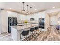 Bright, modern kitchen with granite countertops, stainless steel appliances, and center island at 6253 Black Mesa Rd, Frederick, CO 80516