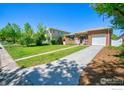 Brick single-Gathering home with a well-maintained front lawn and a paved driveway at 729 Elm St, Denver, CO 80220