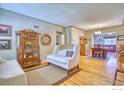 Cozy living room featuring hardwood floors, decorative cabinets and vintage furniture at 729 Elm St, Denver, CO 80220