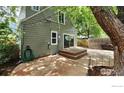 Inviting backyard with a wooden deck, concrete patio, and string lights at 731 Bowen St, Longmont, CO 80501
