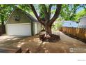 Spacious garage with a basketball hoop and adjacent patio area at 731 Bowen St, Longmont, CO 80501