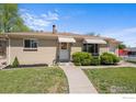 Charming brick home featuring a well-kept lawn and walkway leading to the front door at 7736 Vallejo St, Denver, CO 80221