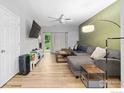 Spacious living room with hardwood floors, lots of natural light, with gray sectional sofa at 804 Summer Hawk Dr, Longmont, CO 80504