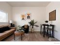 Bright living room with modern art, a cozy sofa, an accent chair, and a dining table at 934 6Th St, Berthoud, CO 80513
