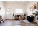 Cozy living room featuring modern decor, a comfortable sofa, and a stylish accent chair at 934 6Th St, Berthoud, CO 80513