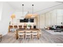 An open-concept living area features a dining space, modern decor, and hardwood floors at 944 Arapahoe Ave # A, Boulder, CO 80302