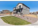 Lovely home with a manicured lawn and tasteful landscaping, complementing the home's exterior at 9882 Cathay St, Commerce City, CO 80022