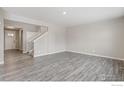 Bright living room featuring sleek flooring and ample space, awaiting personal touches at 9882 Cathay St, Commerce City, CO 80022