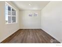 Bright bedroom with large windows and hardwood floors at 9902 Cathay St, Commerce City, CO 80022