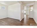 Spacious living room featuring sleek hardwood floors and ample natural light at 9902 Cathay St, Commerce City, CO 80022
