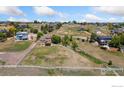 Expansive lot featuring a home with a walkout basement and white fencing around the yard at 10970 E 150Th Pl, Brighton, CO 80602