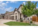 Beautiful home exterior with a well-maintained lawn and welcoming front porch, ideal for relaxation at 11511 E 118Th Ave, Commerce City, CO 80640