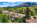 Captivating aerial view of a home with mountain views, surrounded by lush trees and greenery in a tranquil setting at 1350 Lehigh St, Boulder, CO 80305