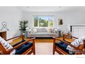 Bright living room with large window showcasing mountain views, stylish seating, and hardwood floors at 1350 Lehigh St, Boulder, CO 80305