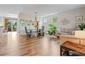 Inviting living and dining space with wood floors, stylish decor, and plenty of natural light at 14675 Golden Eagle Run, Broomfield, CO 80023