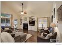 Inviting living room with fireplace, built-in shelving, and large windows at 1613 Golden Bear Dr, Longmont, CO 80504