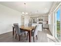 Bright dining room with a view, adjacent to the kitchen with hardwood floors and modern decor at 1800 Vantage Pkwy, Berthoud, CO 80513