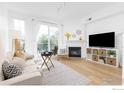 Bright living room features a fireplace, large windows, and an adjacent balcony at 1866 Mallard Dr, Superior, CO 80027