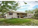 Nice backyard featuring a well-maintained lawn and covered porch at 2091 Tate Ave, Fort Lupton, CO 80621
