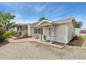 Ranch-style home with covered porch and a small, well-kept yard at 2091 Tate Ave, Fort Lupton, CO 80621