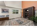 Cozy living area with a wooden bench, stylish decor, and natural light at 2144 Santa Fe Dr, Longmont, CO 80504