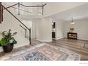 Open-concept living room with hardwood floors and a staircase at 2144 Santa Fe Dr, Longmont, CO 80504