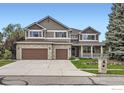 Charming two-story home with a three-car garage and well-manicured lawn at 2215 Parkview Dr, Longmont, CO 80504