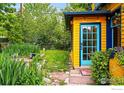 Lush backyard featuring a stone pathway, vibrant greenery, and string lights, creating an inviting outdoor space at 2320 22Nd St, Boulder, CO 80304