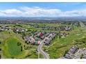 Aerial view of a neighborhood with homes surrounded by lush golf courses at 23570 E Holly Hills Way, Parker, CO 80138