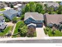 An aerial view showcasing a home's exterior, complete with a well-manicured lawn at 23570 E Holly Hills Way, Parker, CO 80138