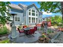 Spacious backyard featuring a patio area with a dining table and seating for outdoor relaxation at 23570 E Holly Hills Way, Parker, CO 80138
