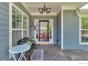 Inviting front porch with seating area and decorative touches provides a welcoming entrance at 23570 E Holly Hills Way, Parker, CO 80138