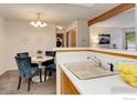 Charming dining area with views of the kitchen and a convenient breakfast bar at 2800 Sundown Ln # 109, Boulder, CO 80303