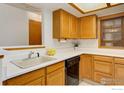 Well-lit kitchen features classic wood cabinetry, white countertops, and modern appliances at 2800 Sundown Ln # 109, Boulder, CO 80303