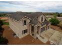 Beautiful aerial view of a two-story home with a three-car garage and meticulously maintained grounds at 3106 Megan Way, Berthoud, CO 80513