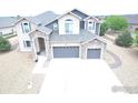 Beautiful two-story house with a two-car garage, stone accents, and a well-maintained front yard at 3106 Megan Way, Berthoud, CO 80513