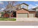 Inviting two-story home with a brick facade, a cozy porch, and a well-kept lawn at 4094 Bimini Ct, Boulder, CO 80301